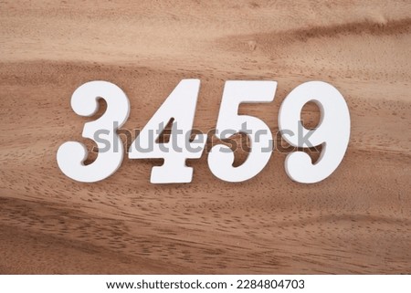 White number 3459 on a brown and light brown wooden background.
