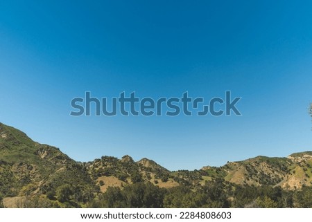 Malibu California Creek State Park Mountain View Of Hiking Trails With Rolling Green Hillsides, Trees, Grass Hills, And Clear Blue Skies Royalty-Free Stock Photo #2284808603
