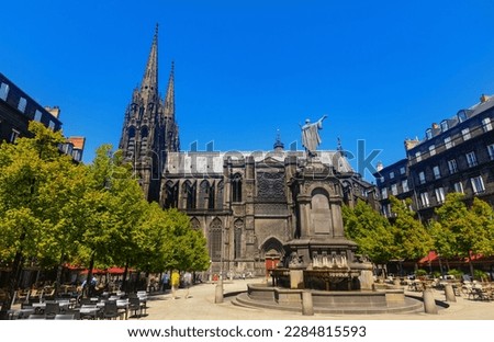 Towering over Clermont-Ferrand city gothic cathedral Notre-Dame-de-l'Assomption building from black lava, France Royalty-Free Stock Photo #2284815593