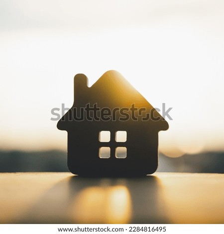 Wooden house model on wood background, a symbol for construction , ecology, loan, mortgage, property or home.