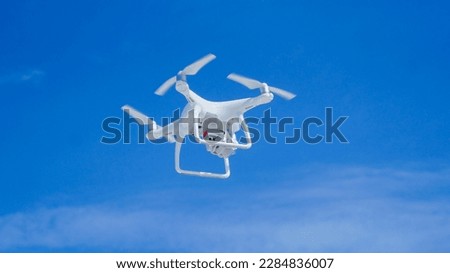 
low angle shot of a drone on a blue sky