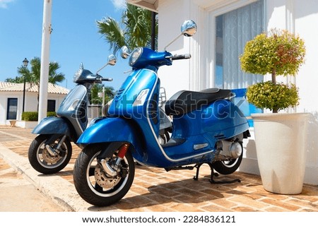 side view of moped vehicle blue color. moped vehicle outside. moped vehicle in the street. Royalty-Free Stock Photo #2284836121