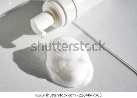 Photo of the texture of cosmetic foam with a bottle. Royalty-Free Stock Photo #2284847963