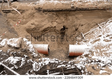 Repair of roads and communications. Replacement of sewer pipes and drains. pipes. Site on a city street. communications repair. Royalty-Free Stock Photo #2284849309