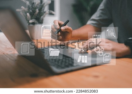 A business developer uses the Kanban board framework on a laptop for agile software development and lean project management. This tool facilitates fast changes and backlog management. Royalty-Free Stock Photo #2284852083