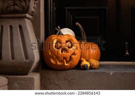 Jack O Lantern and Pumpkin Halloween Display in front of a Door to a Home in Greenwich Village of New York City Royalty-Free Stock Photo #2284856143