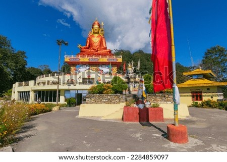 Wide angle view of Holy statue of Guru Padmasambhava or born from a lotus, Guru Rinpoche, Blue sky and white clouds, Samdruptse, Sikkim, India.