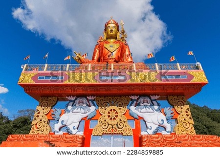 Holy statue of Guru Padmasambhava or born from a lotus, Guru Rinpoche, was a Indian tantric Buddhist Vajra master who taught Vajrayana in Tibet. Blue sky and white clouds, Samdruptse, Sikkim, India. Royalty-Free Stock Photo #2284859885