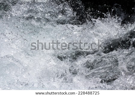 water wave with splashes, abstract background.
