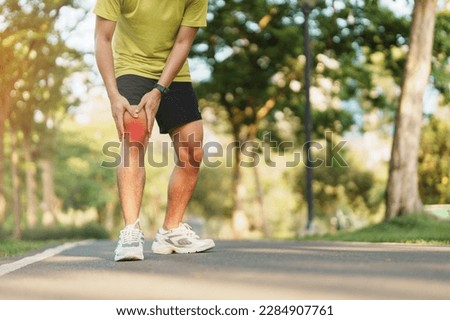 Young adult male with muscle pain during running. runner have knee ache due to Runners Knee or Patellofemoral Pain Syndrome, osteoarthritis and Patellar Tendinitis. Sports injuries and medical concept Royalty-Free Stock Photo #2284907761