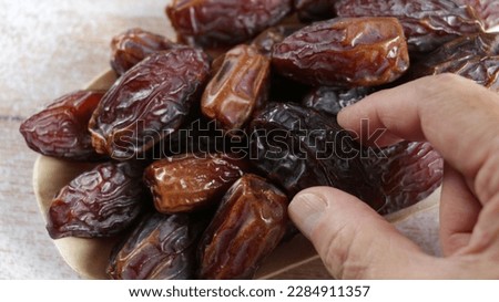 Kurma Medjool (medjool dates), pleasantly plump, larger, darker, and more caramel-like in taste. Iftar food, breaking the fast. Royalty-Free Stock Photo #2284911357