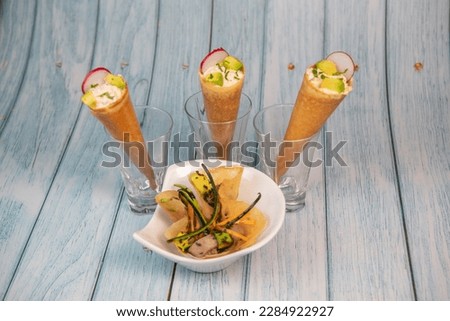 Brick with marinated red tuna, soy sauce, nuoc mam, ginger, black sesame, avocado, carrot slices, courgette and cornet with pieces of red tone Royalty-Free Stock Photo #2284922927