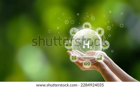 Monlikul's Clean Hydrogen Energy in the concept of environment environmentally friendly industry nature and alternative energy Future climate-friendly energy Connect icon on hand on green background Royalty-Free Stock Photo #2284924035