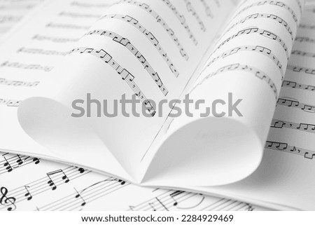 Sheets of paper with music notes as background, closeup Royalty-Free Stock Photo #2284929469