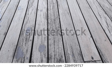 Wood plank floor background from natural tree. The texture of the hard and durable wood plank flooring has a beautiful dark pattern