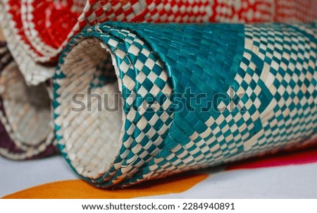 Paninggahan, Solok, March, 2023. Crafts of woven pandanus (Pandanus tectorius) with natural colors. Pandan matting is used to make wallets, bags and others.