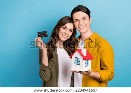 Photo of charming pretty husband wife dressed shirts buying new house empty space isolated blue color background