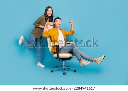 Full body photo poster advert couple students of new luxury chair for working studying comfortable place fists up isolated on blue color background Royalty-Free Stock Photo #2284941617
