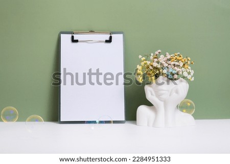 Message board mockup with creative plaster head vase with flowers. Mental health concept copy space. Royalty-Free Stock Photo #2284951333