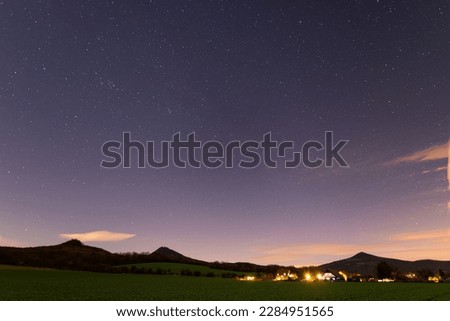 Beautiful night sky over the village in highlands, Andromeda Galaxy and Milky way