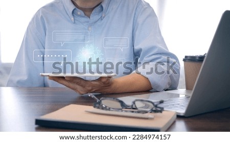 Businessman using technology smart robot AI, digital ai chatbot, on digital tablet. System artificial intelligence on virtual screen. 
