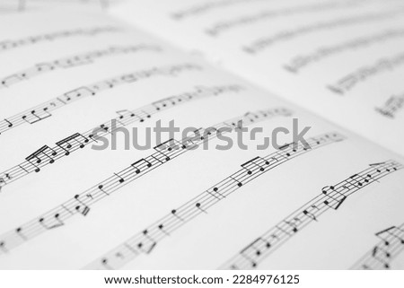 Sheet music book as background, closeup view