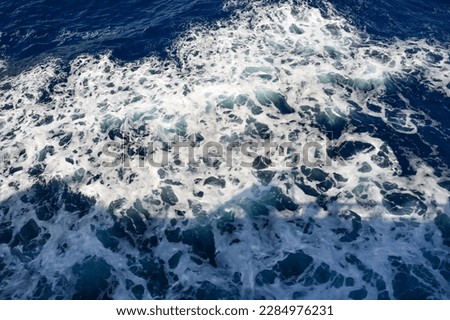 Background of sea foamy blue waves for the entire frame. Natural sea background and texture