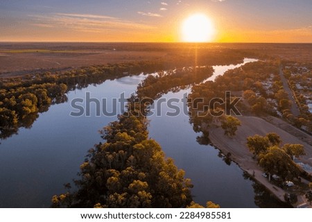 Aerial view of sunset over a river divided by a narrow island Royalty-Free Stock Photo #2284985581