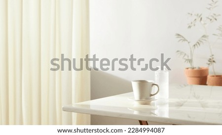 A room with a calm atmosphere, with clay pots placed
in front of the wall and curtains letting in natural light.
Glass bottles, coffee, and various objects on a marble
table. Royalty-Free Stock Photo #2284994087