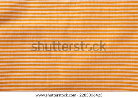 Orange and white striped cotton texture. Fabric textile background