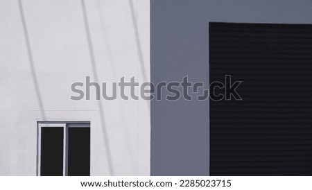 Sunlight and shadow on Glass sliding Window with roller shutter door of white warehouse building wall in perspective view, Minimal Exterior Architecture Background