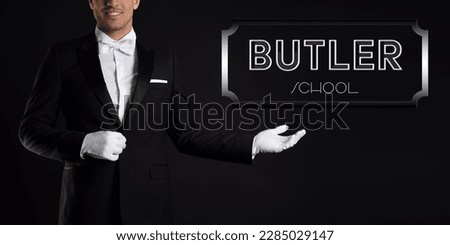 Man in elegant suit pointing at sign Butler School on black background, banner design