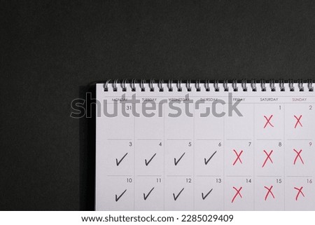 Calendar with ticks and crosses, depicting four day work week concept. Copy space. Royalty-Free Stock Photo #2285029409