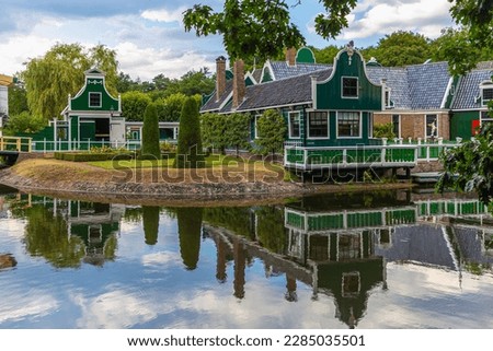 Merchant's house in Dutch Open Air Museum, Openluchtmuseum, Arnhem, Netherlands, July 29, 2022. Beautiful, old Dutch building with green authentic facade with reflection in the lake Royalty-Free Stock Photo #2285035501