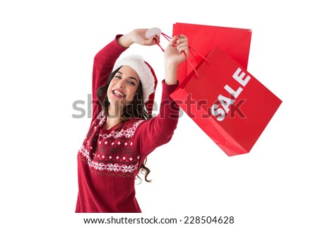 Pretty brunette showing sale bag and shopping bag at home in the living room