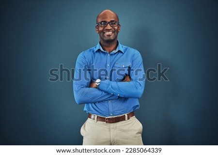 Confident, proud business man feeling happiness, confidence and motivation indoors. Portrait of a smiling male tech worker ready to work in a leadership role in his corporate company