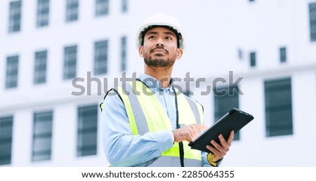 Thinking architect browsing digital tablet, analysing building plans for city planning, residential or office development. Architectural engineer or contractor checking online blueprint on technology Royalty-Free Stock Photo #2285064355