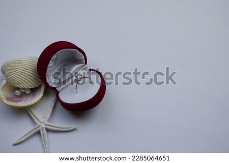 Ring in box, ring in red box, placed on white background.  pearl, mussel, star, copy, space