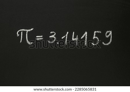 Number Pi written in chalk on a blackboard