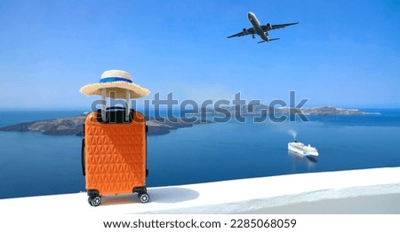 Banner of travel concept with Orange luggage and hat as landscape view of Oia town in Santorini island in Greece , Greek landscape as blue sky background Royalty-Free Stock Photo #2285068059