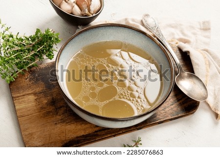 Broth in Bowl on gray background, healthy food