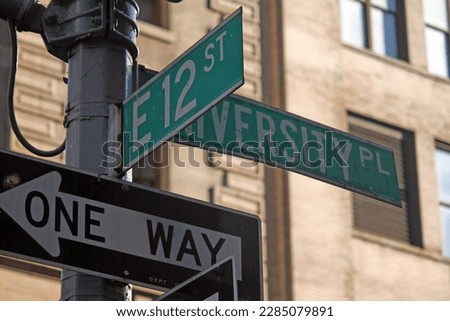 Green East 12th Street and University Place traditional sign in Midtown Manhattan in New York City