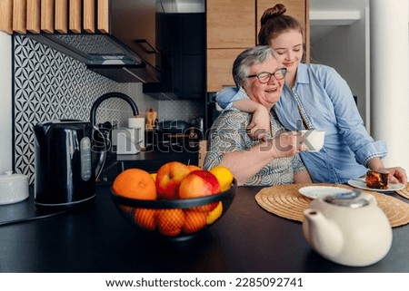 Special moments together. an attractive woman teen granddaughter visiting granny for tea. Royalty-Free Stock Photo #2285092741