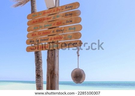 Funny sign with weather forecast at Banana Bay Beach