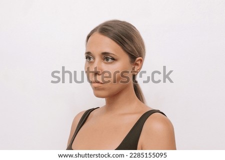 Portrait of a young caucasian woman with clear highlighted cheekbones on a white background. Plastic surgery buccal fat removal. Result of cosmetic surgery Royalty-Free Stock Photo #2285155095