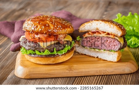 Two hamburgers on the wooden board close-up Royalty-Free Stock Photo #2285165267
