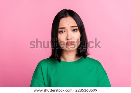 Portrait of unhappy sad woman straight hairstyle oversize t-shirt pouted lips looks disappointed isolated on pink color background Royalty-Free Stock Photo #2285168599
