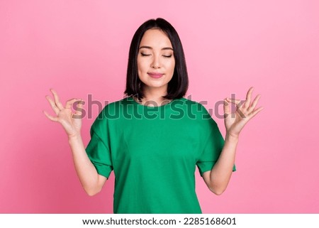 Photo of nice pretty good mood girl with bob hairdo dressed green t-shirt eyes closed meditating isolated on pink color background