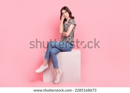 Full body portrait of offended unsatisfied lady sit podium cube look empty space isolated on pink color background Royalty-Free Stock Photo #2285168673