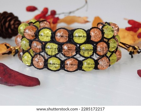 Colorful friendship bracelet on a white. Colorful bracelet and leafs